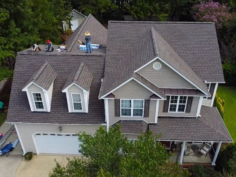 roofing-crew-installing-architectural-shingles-two-story-home
